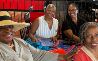 Four African American women set at a table