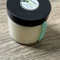 Small container with body scrub. Label on the top reads Wazuri cosmetics